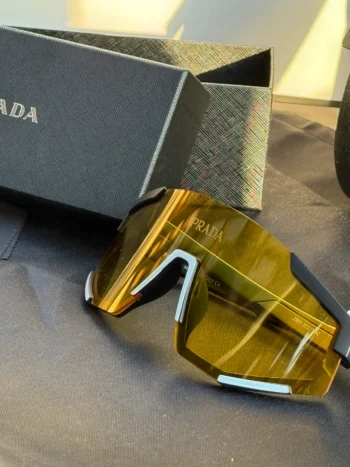 Prada Symbole Shield Sunglasses – Amber Yellow Lens with Black & Silver Accents